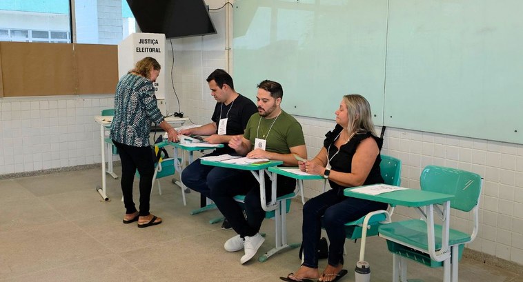 Mesários atuam em seção eleitoral durante o processo de votação nas eleições brasileiras.